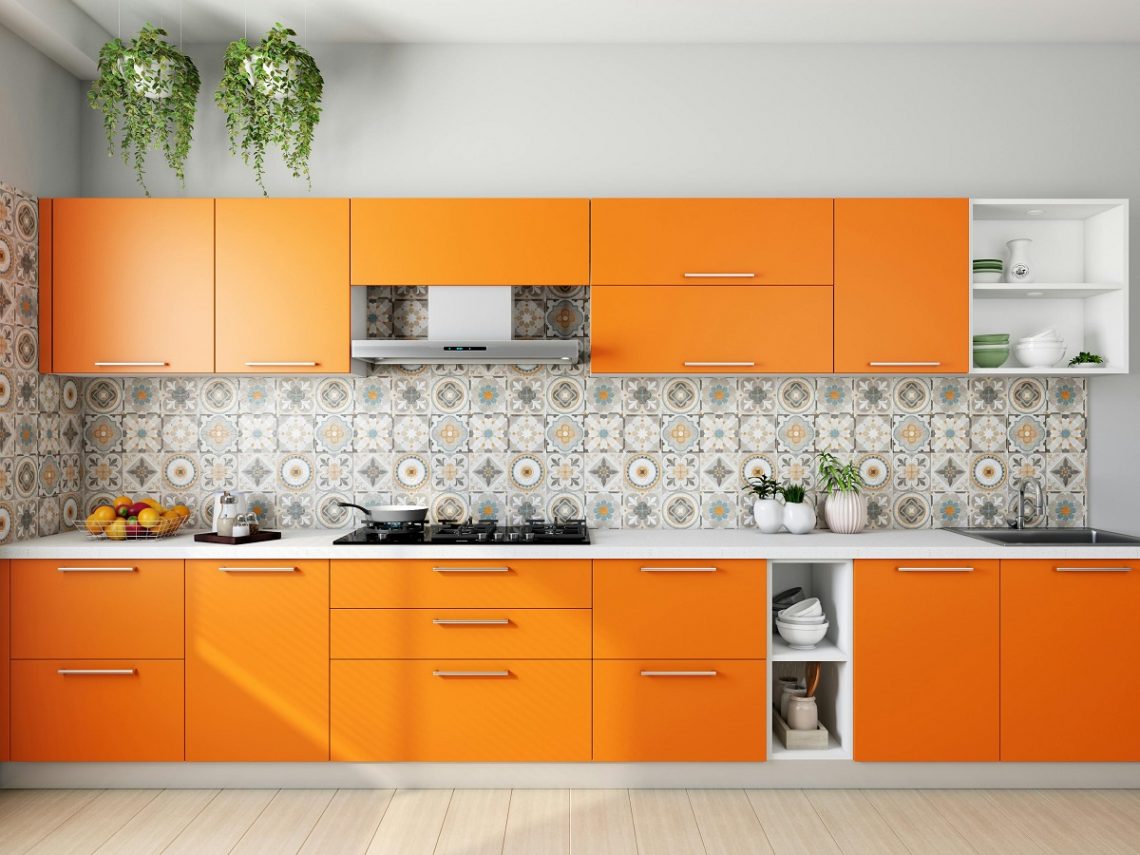 white and orange kitchen with a patterned accent wall