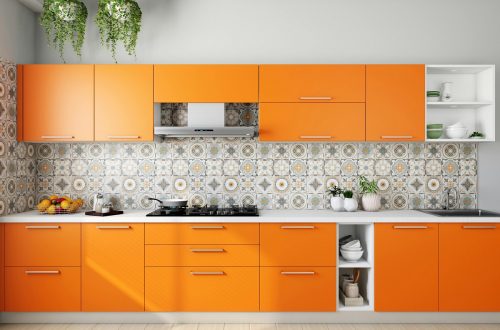white and orange kitchen with a patterned accent wall