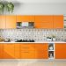 white and orange kitchen with a patterned accent wall